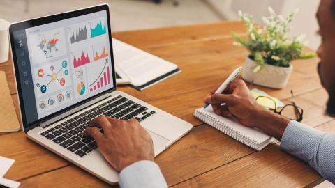 Man creating charts on a laptop